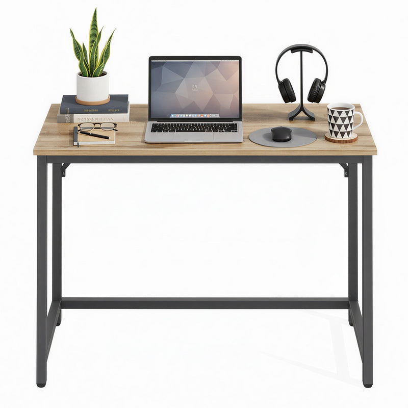 Vasagle desk styled with a laptop, plant, and desk accessories
