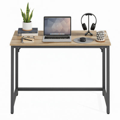 Vasagle desk styled with a laptop, plant, and desk accessories