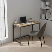 Vasagle desk in a bedroom with a chair, laptop, and shelving