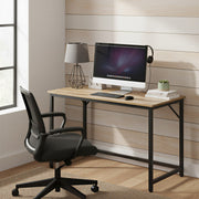 Vasagle desk set up with a monitor and office chair against a wood-panelled wall