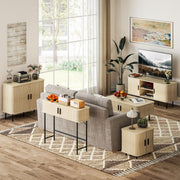 Console table behind a grey sofa in a bright living room