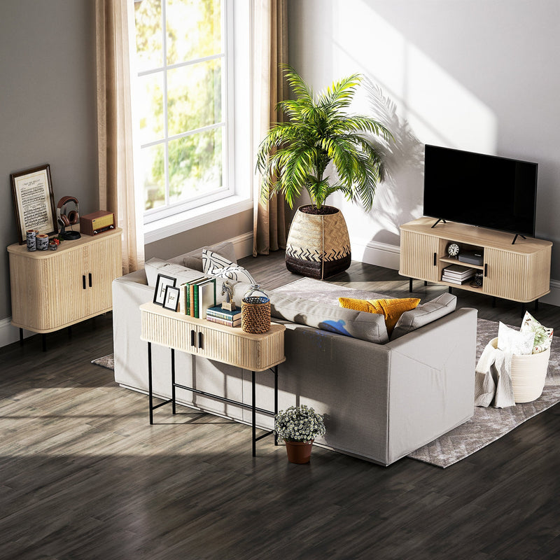 Console table beside a sofa in a living room with a television unit and plants