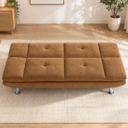 Brown convertible sofa bed laid flat in a bright living room