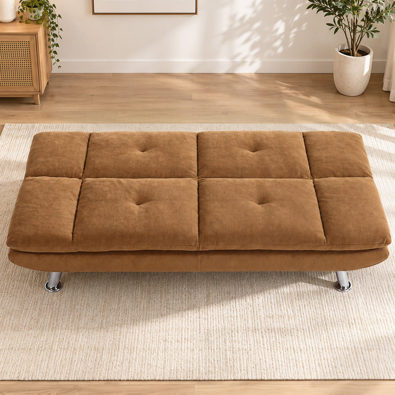 Brown convertible sofa bed laid flat in a bright living room