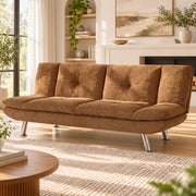 Brown convertible sofa bed in sofa mode in a styled lounge