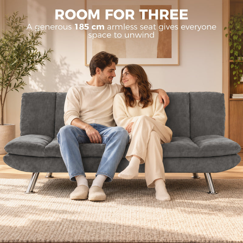Couple sitting side by side on the grey 185 cm armless sofa bed