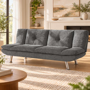 Grey convertible sofa bed in sofa mode in a styled lounge