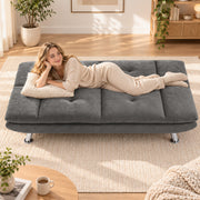Woman lying on the grey sofa bed in bed mode