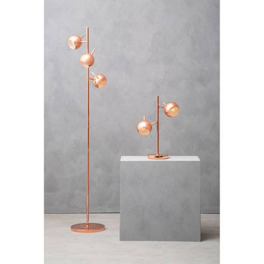 Copper two light table lamp on a bedside table