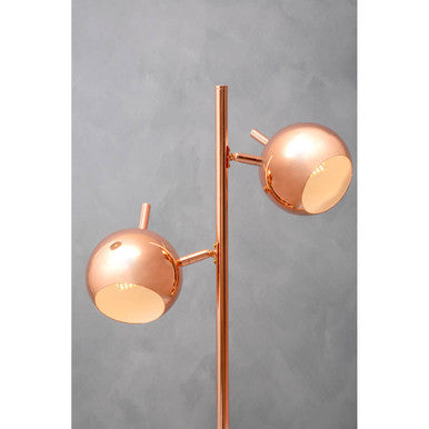 Copper twin light lamp styled on a console table