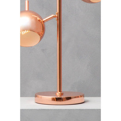 Copper two light table lamp on a desk