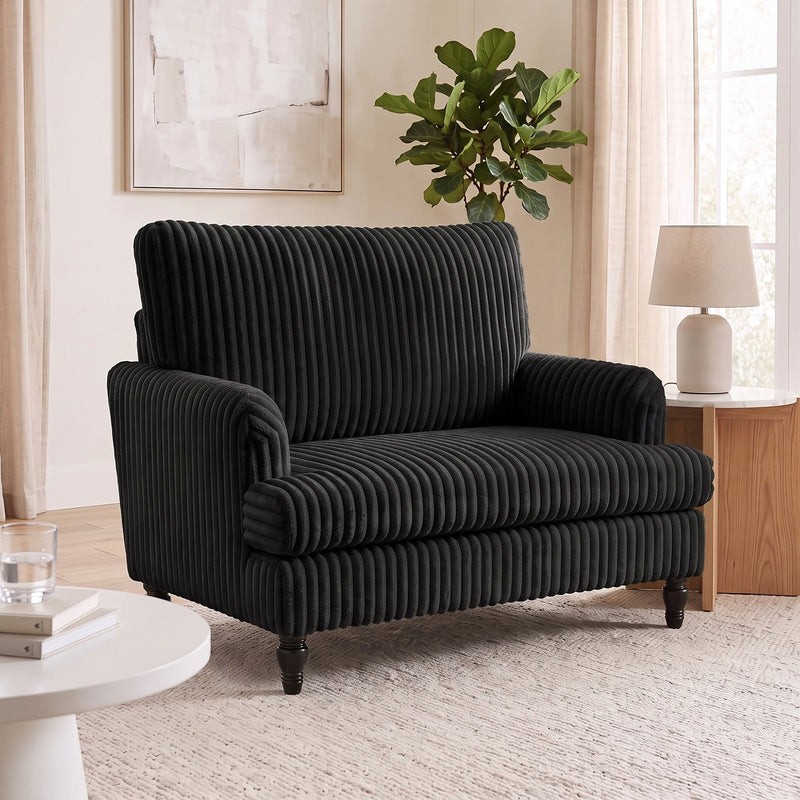 Living room scene with the armchair, a round side table and a fiddle leaf fig