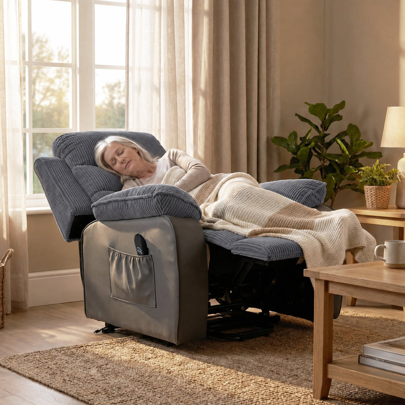 Woman asleep in the reclined dark grey chair beside a wooden table