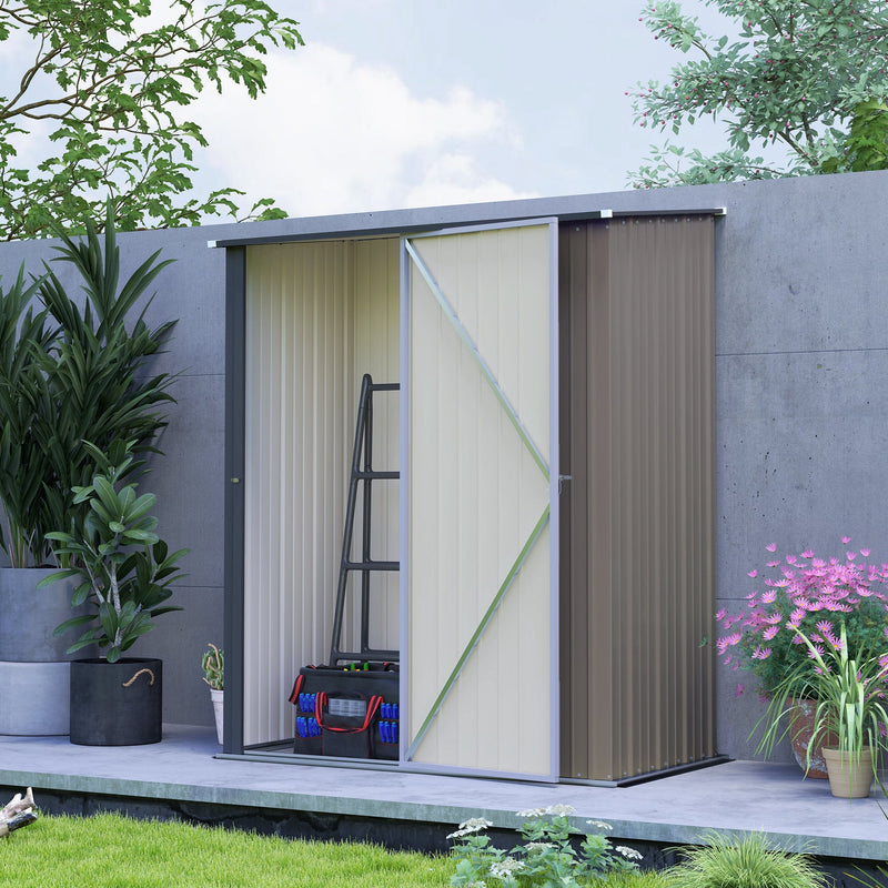 Shed against a grey wall with the door open and a folded step ladder stored inside