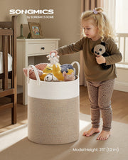 Cotton rope laundry basket styled in a bedroom holding folded clothes