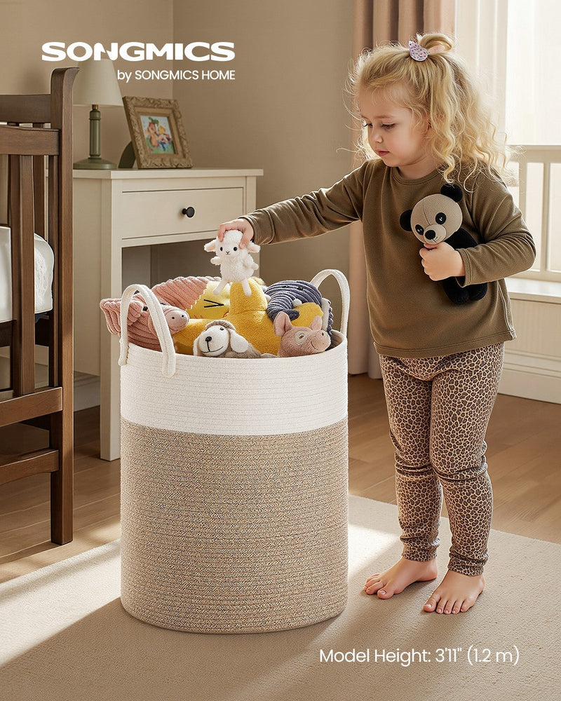 Cotton rope laundry basket styled in a bedroom holding folded clothes