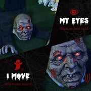 Close-up of the zombie prop's glowing red eyes and open mouth in the dark