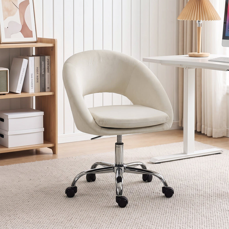 Cream velvet desk chair in a home office with a bookcase and adjustable desk