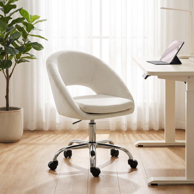 Cream desk chair beside a height-adjustable desk with a potted plant