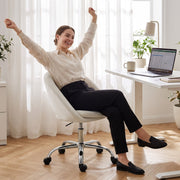 Woman stretching while seated in the cream desk chair at a desk