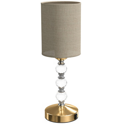Crystal bedside lamp with a drum shade and three faceted crystal accents, studio shot