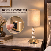 Rocker switch graphic with a finger pressing the switch on the lamp base