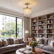 Gold Tone ceiling light above a living room bookshelf and sofa