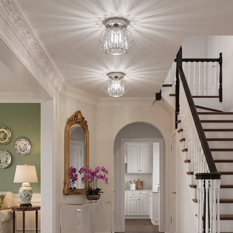 Bright hallway with two crystal ceiling lights above a staircase and arched door