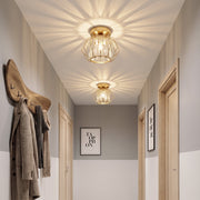 Two crystal ceiling lights glowing in a narrow hallway above coat hooks
