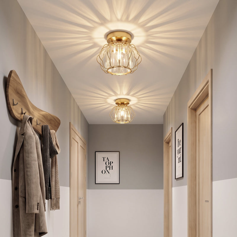 Two crystal ceiling lights glowing in a narrow hallway above coat hooks
