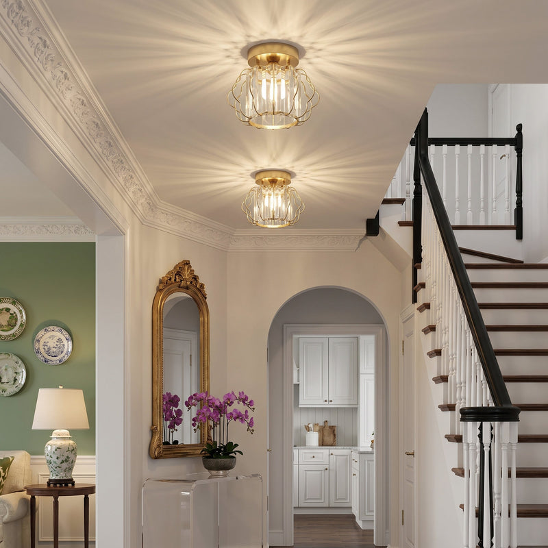 Two crystal ceiling lights in an entrance hall beside a staircase and arched doorway