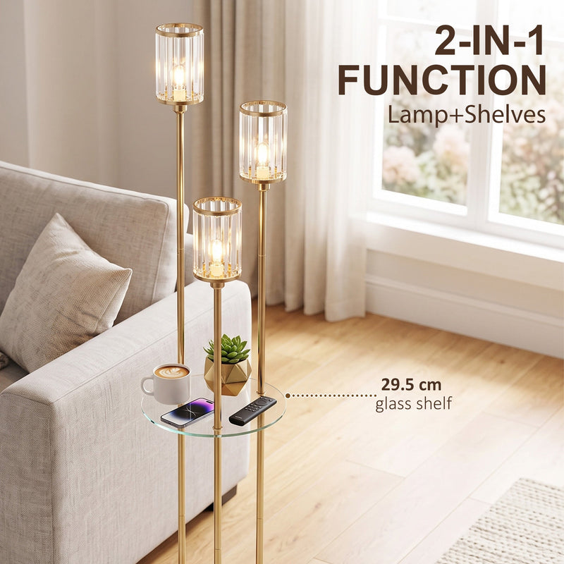 Gold tone floor lamp with a 29.5 cm glass shelf holding a cup, phone and remote