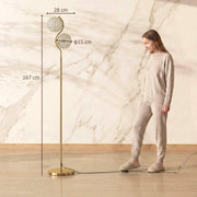 Gold crystal globe floor lamp beside a standing woman with 167 cm height, 28 cm width and 15 cm globe diameter labelled