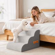 Woman lying on a bed stroking a small white dog standing on the curved stairs