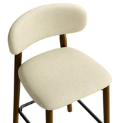 Close-up of a beige padded seat and curved backrest
