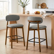 Pair of grey bar stools at a kitchen island with a bowl of fruit
