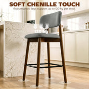Grey bar stool at a marble counter with rubberwood leg and foot glide call-out