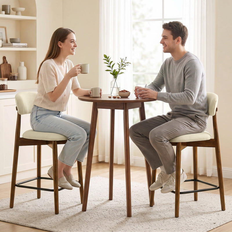 Couple having coffee at a round table on two beige bar stools