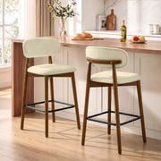 Two beige bar stools at a wooden kitchen counter