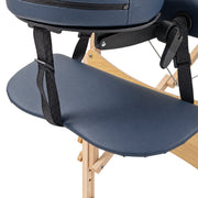 Close-up of the padded arm support and strap on the massage table