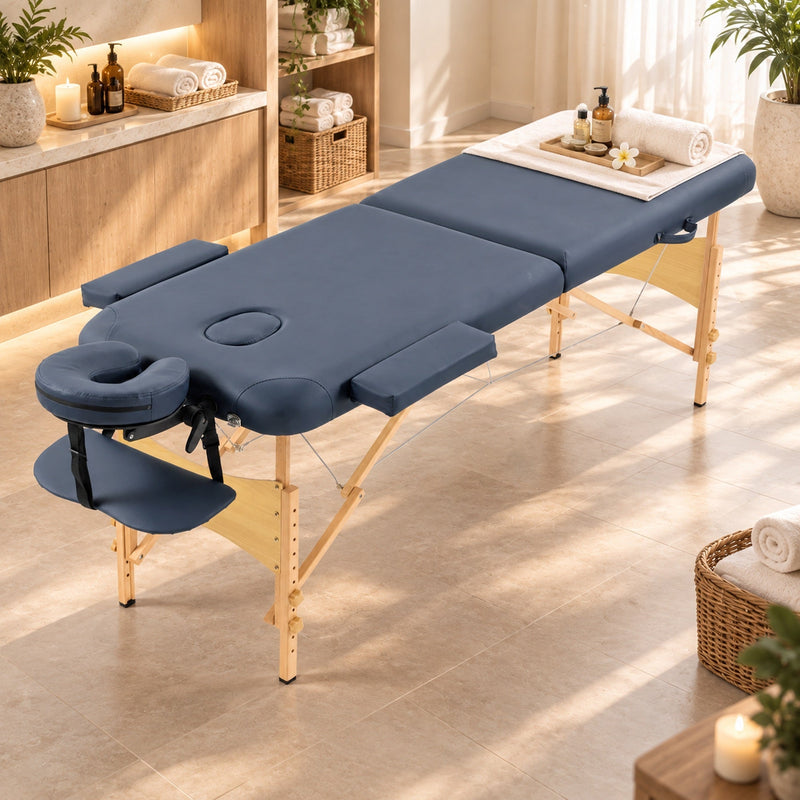 Angled view of the massage table showing the headrest and side arm supports