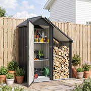 Firewood shed against a garden fence with tools in the cabinet and stacked logs