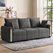 Dark grey velvet 3 seater sofa in a bright living room on a patterned rug