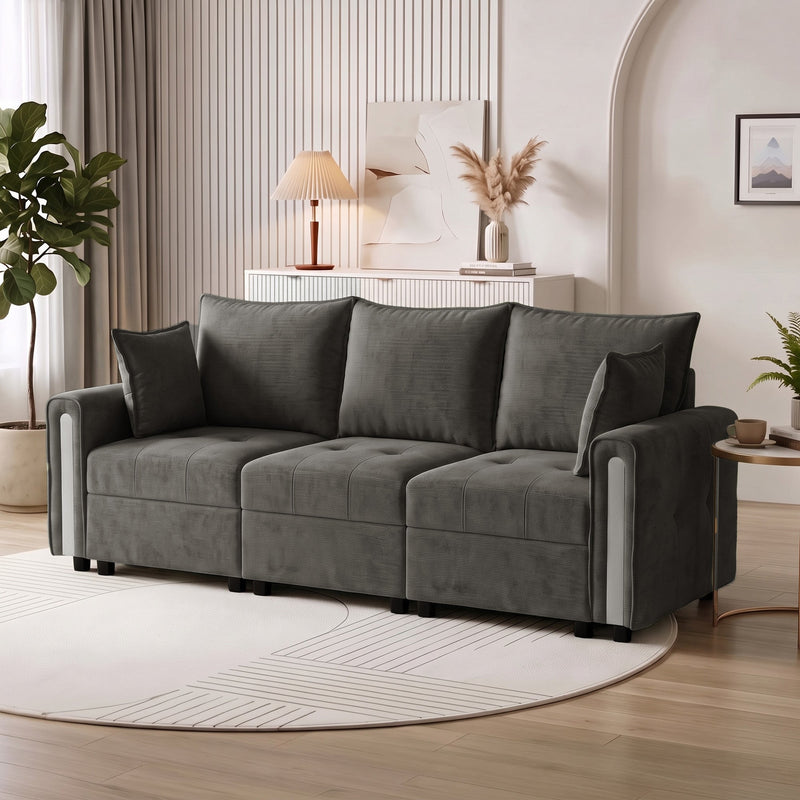 Dark grey velvet storage sofa in a living room beside a side table and round rug