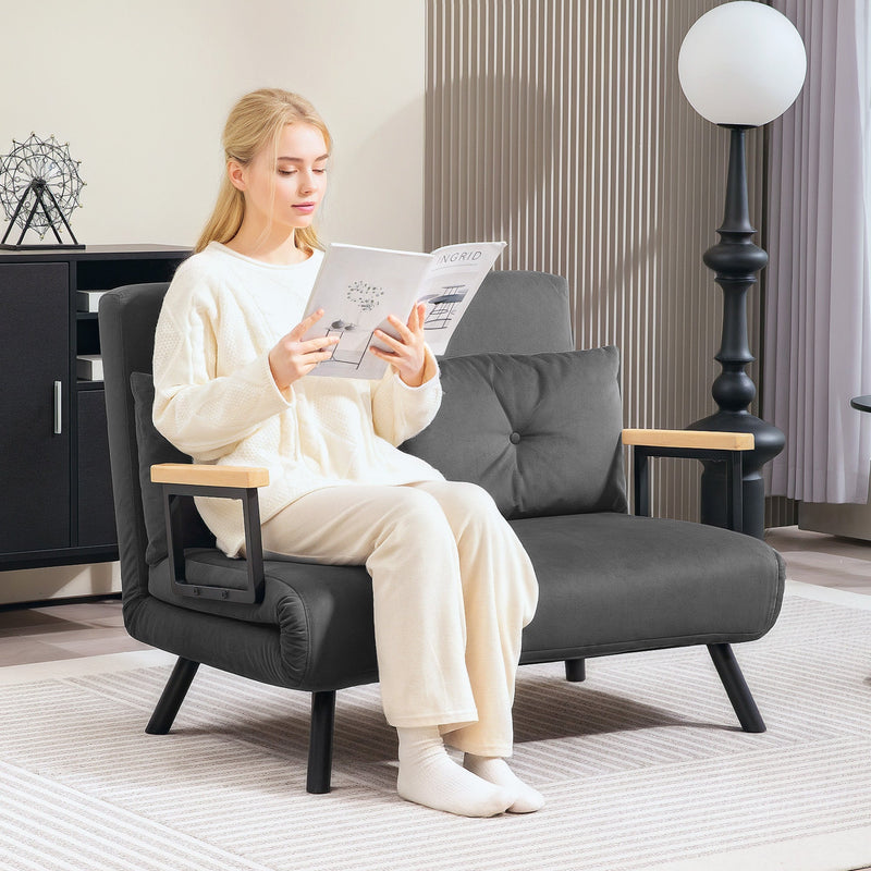 Woman reading in the dark grey sofa reclined in the lounge configuration