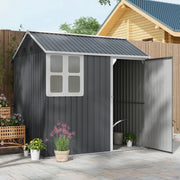 Dark grey metal shed on a patio with its single door open, showing a watering can inside