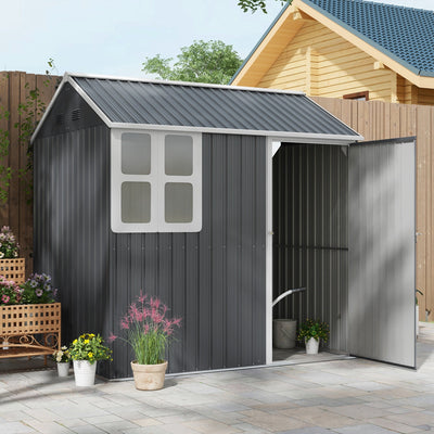 Dark grey metal shed on a patio with its single door open, showing a watering can inside