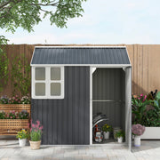 Front view of the shed with the door open and an internal shelf above garden equipment