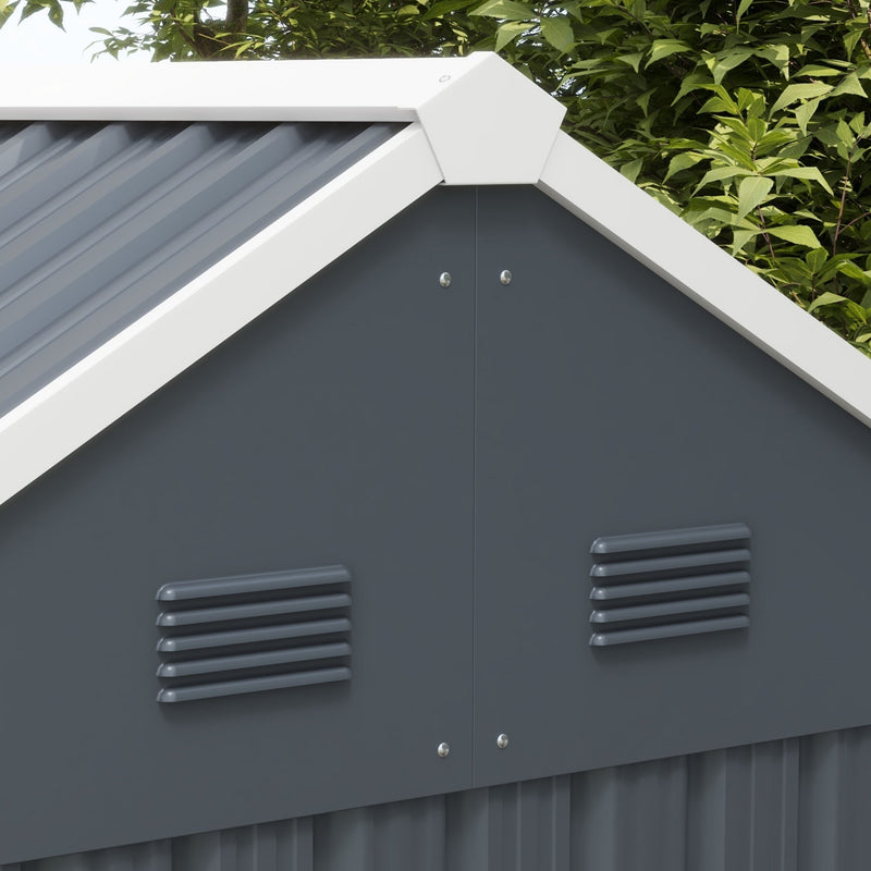Close-up of the gable end showing two louvred air vents below the white ridge trim