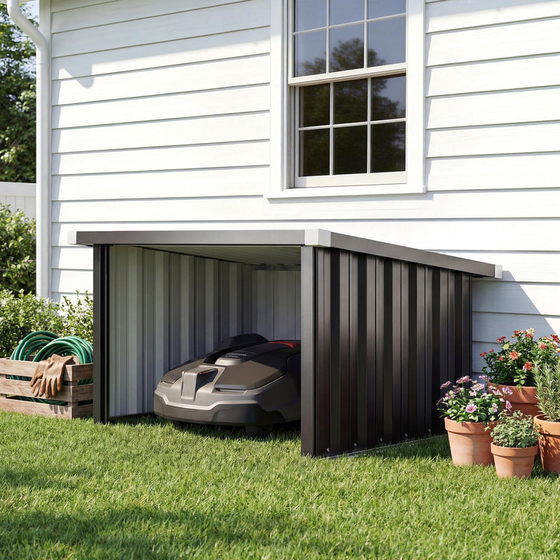 Robot mower garage beside a white house wall sheltering a robotic mower